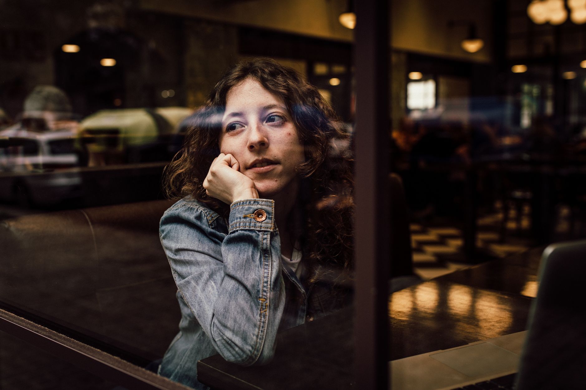 Femme pensive devant une fenêtre